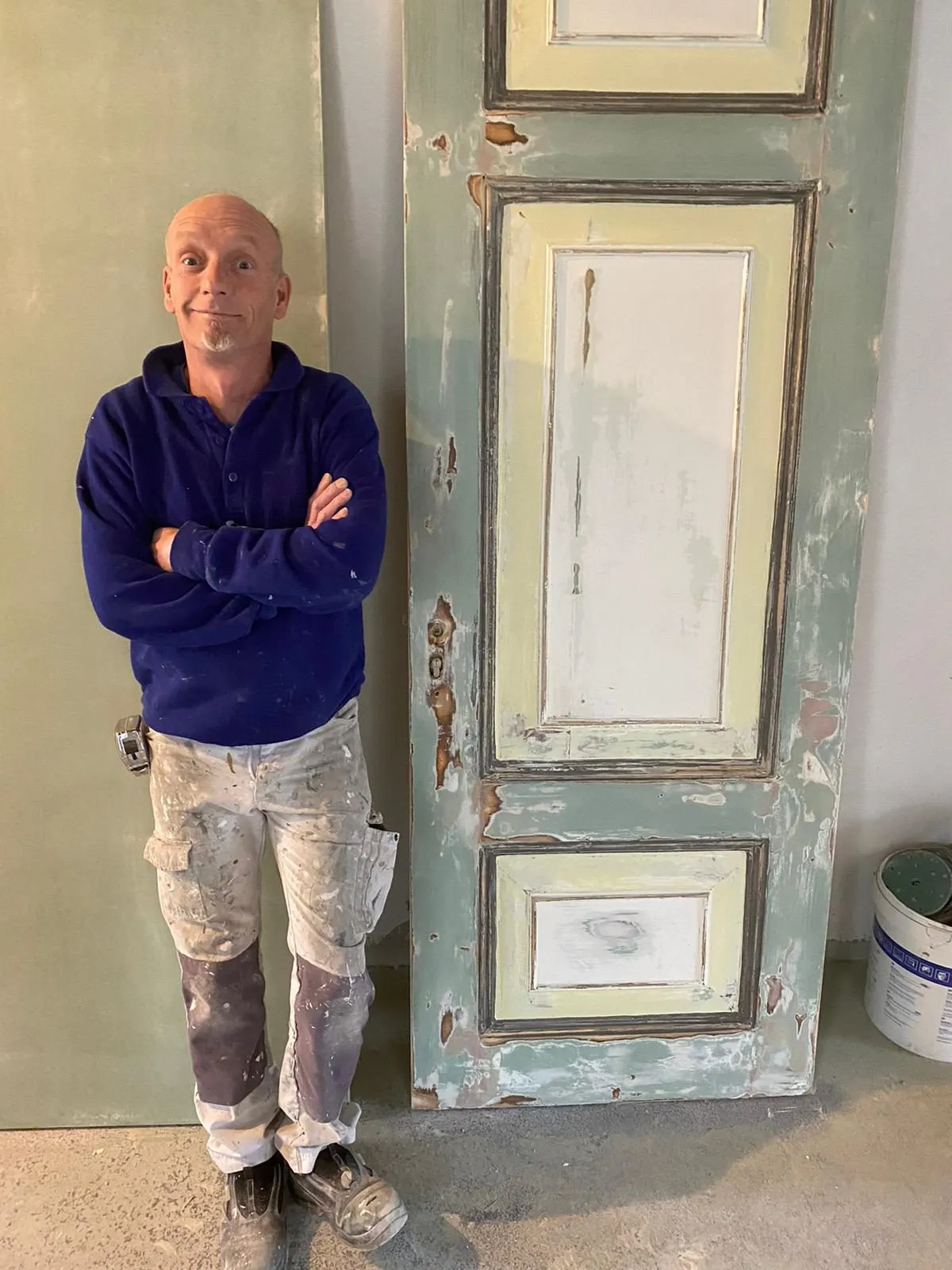 David Los met een hersteld deurpaneel in de werkplaats